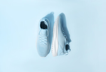 Blue pastel color sneakers on background
