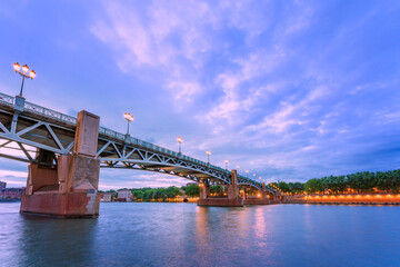 Panoramic view of River Garonne and Saint Peter bridge in the French city of Toulouse at dusk