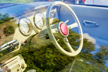 Retro car interior, dashboard and steering wheel with controls in classic american car