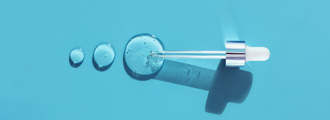pipette drop of serum test on a blue background	
