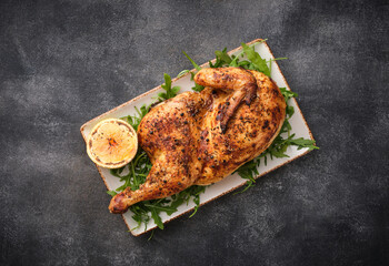 Half roasted chicken Piri Piri served with lemon . Grilled poultry