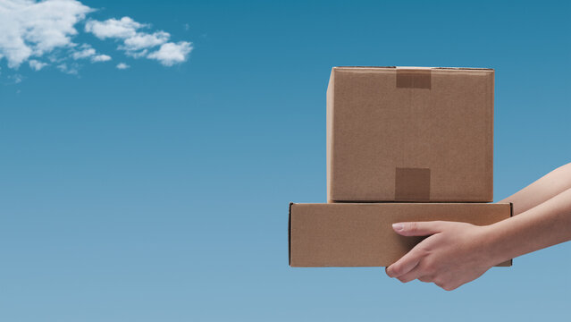 Hands holding delivery boxes