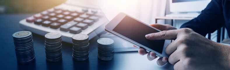 businessman working on desk office with using a calculator to calculate the numbers, finance accounting concept