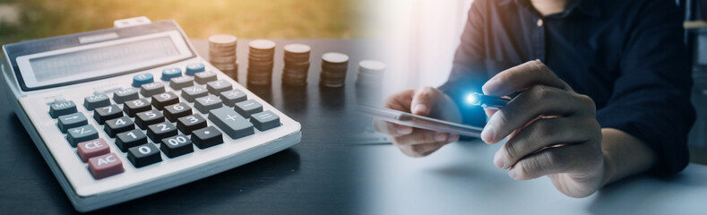 businessman working on desk office with using a calculator to calculate the numbers, finance accounting concept