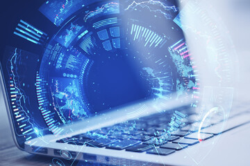 Close up of laptop with creative round digital business chart interface on blurry backdrop. Stock, finance, trade and technology concept. Double exposure.