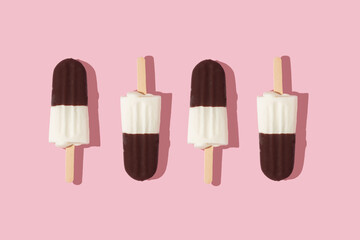 Summer creative pattern with ice cream popsicles  on pastel pink background.  70s, 80s or 90s retro aesthetic fashion idea. Minimal summer idea.