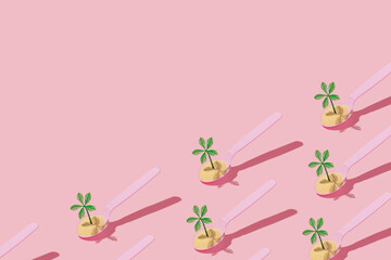 Summer tropical creative pattern with sand and palm tree figurines in pink spoon on pastel pink background. 80s, 90s retro fashion aesthetic summer concept. Minimal pop art  concept. - obrazy, fototapety, plakaty