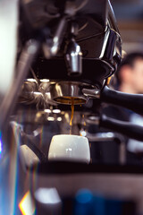 Espresso shot getting brewed into beautiful cup. Artistic photo.