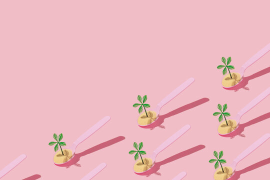 Fototapeta Summer tropical creative pattern with sand and palm tree figurines in pink spoon on pastel pink background. 80s, 90s retro fashion aesthetic summer concept. Minimal pop art  concept.