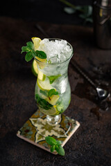 Mojito cocktail with mint leaves and lemon slices. Tropical rum-based cocktail