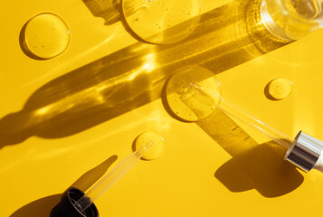 pipette drop of serum test on a yellow background sun glare	
