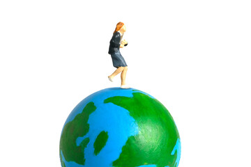 Miniature people toy figure photography. Study abroad and educational ceremony concept. A Young girl pupil running above earth globe isolated on white background
