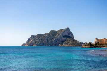Rock of Calpe, in Alicante, illuminated in the morning by the sun with the buildings on the right.