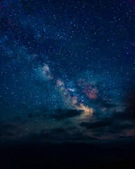 beautiful starry nebula in the night sky with clouds