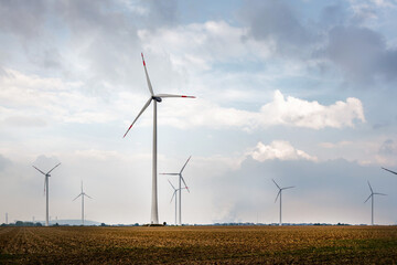 Crops with windmills and power plant on the horizon.