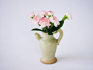 Pink white pastel Dianthus Carnation flowers in vase on embroidered Clove pink still life for background or wallpaper text letter ,mother's day ,women's day soft color romantic love tone copy space 