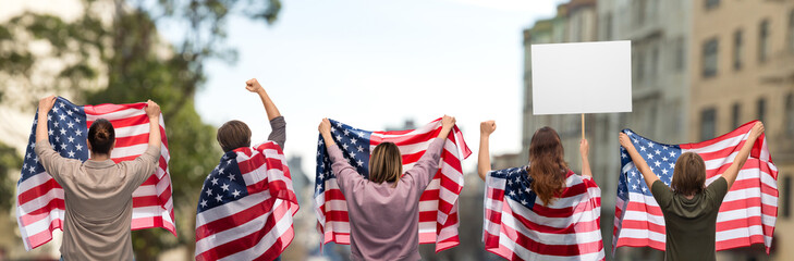 independence day, patriotic and human rights concept - group of people with flags of united states of america and poster protesting on demonstration over city street background