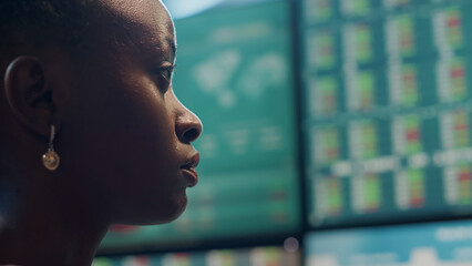 Hedge fund trader analyzing real time stocks on monitors, looking at financial exchange statistics...