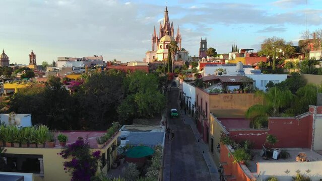 Aerial Drone Shot From Narrow street in San Miguel de Allende Cathedral at evening light in Guanajuato, Mexico.