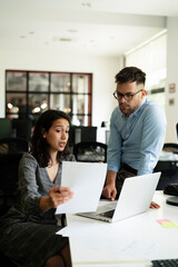 Colleagues in office. Businesswoman and businessman discussing work in office..