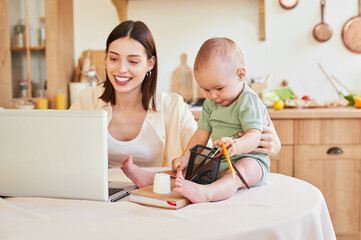 Multitasking mom planning a new project in her home office.
