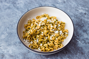 healthy plant-based food, vegan spinach and dairy-free ricotta pasta bowl with wholemeal spirals