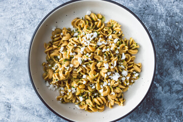 healthy plant-based food, vegan spinach and dairy-free ricotta pasta bowl with wholemeal spirals