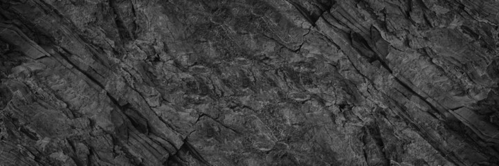 Obraz premium Black white rock texture. Rough mountain surface. Close-up. Stone background with space for design. Web banner. Wide. Panoramic.