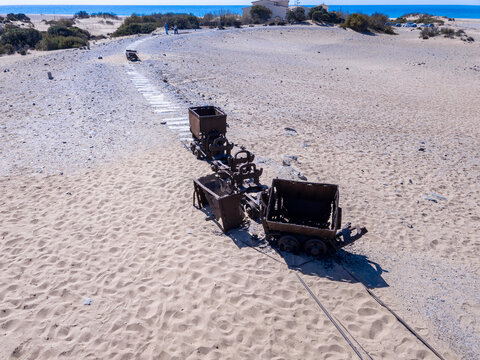 Abandoned mining wagons on a beach