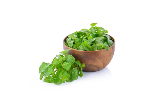 Fresh Mint Leaves In Wooden Bowl Isolated On White Background