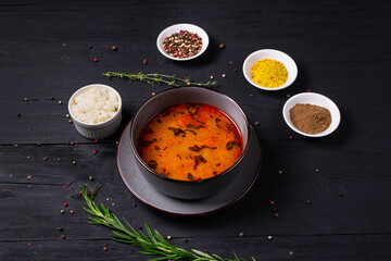 sundubu soup with rice. on a black wooden background