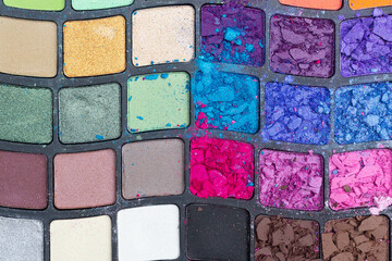 Broken eyeshadow palette. View from above. Background for the beauty sphere. Place for text. Copy space.
