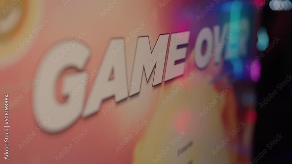 Aufkleber extreme closeup on game over text on computer screen after failing level in online space shooter on 