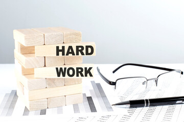 HARD WORK is written on wooden blocks on a chart background