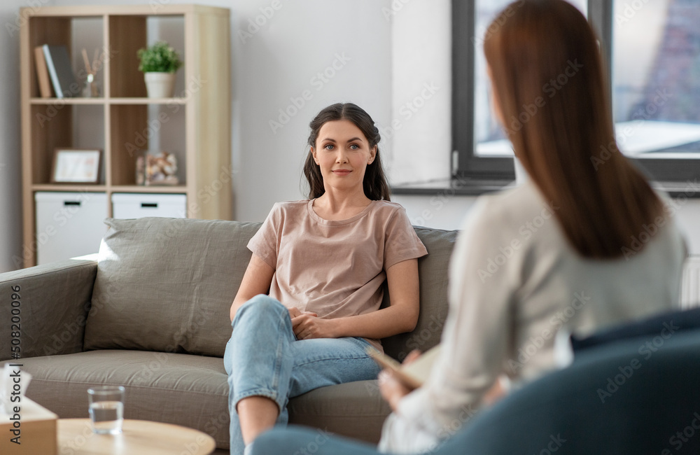 Wall mural psychology, mental health and people concept - young woman patient and woman psychologist at psychot