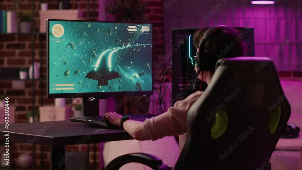 Aufkleber over shoulder view of gamer girl relaxing and streaming on internet fast paced space shooter simulat