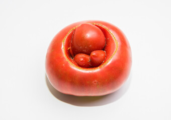 A strange shape of a ripe tomato in the form of hemorrhoids