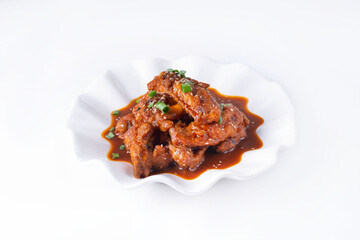 chicken wings with oyster sauce in a white plate on a white background