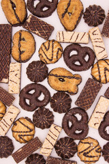 Chocolate biscuits and waffles on light background