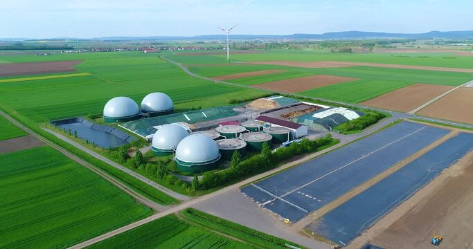 Camera flight over biogas plant from pig farm. Renewable energy from biomass. Modern agriculture European Union