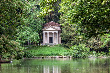 Fototapeta na wymiar The Temple of Swan Lake, also known as the neoclassical Temple of Piermarini, is a neoclassical belvedere which is reflected in the pond of the Royal Gardens of Monza.