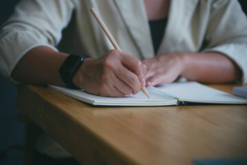 Planner'hand write meeting agenda at Calendar to Meeting online at home. Business Woman plan daily appointment and note schedule in diary at office desk. Reminder event concept.