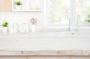 Empty wooden table top with blurred kitchen window area background