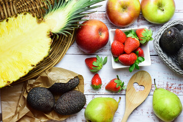 Assorted fruit on white rustic table, zenith view. Healthy food.