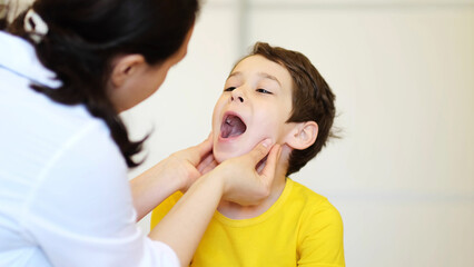 Doctor examining child. Laryngologist, a child with a doctor. The boy in the office of a pediatrician, medical examination
