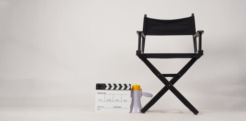 Black director chair and white clapper board or movie slate and megaphone on white background..