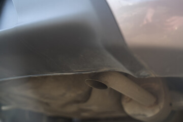 Environmental pollution. The exhaust pipe of a running car. Smoke from the vehicle