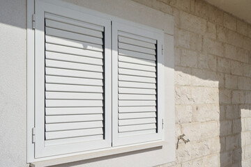 Plastic external window shutters on a residential building