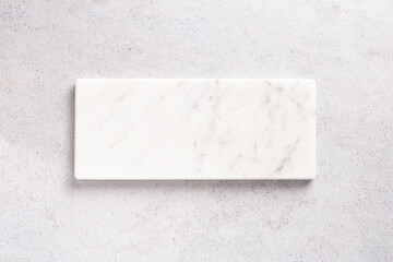 Empty light marble podium for product display on gray background