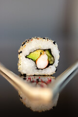 Assorted sushi of avocado and crab sticks with sesame